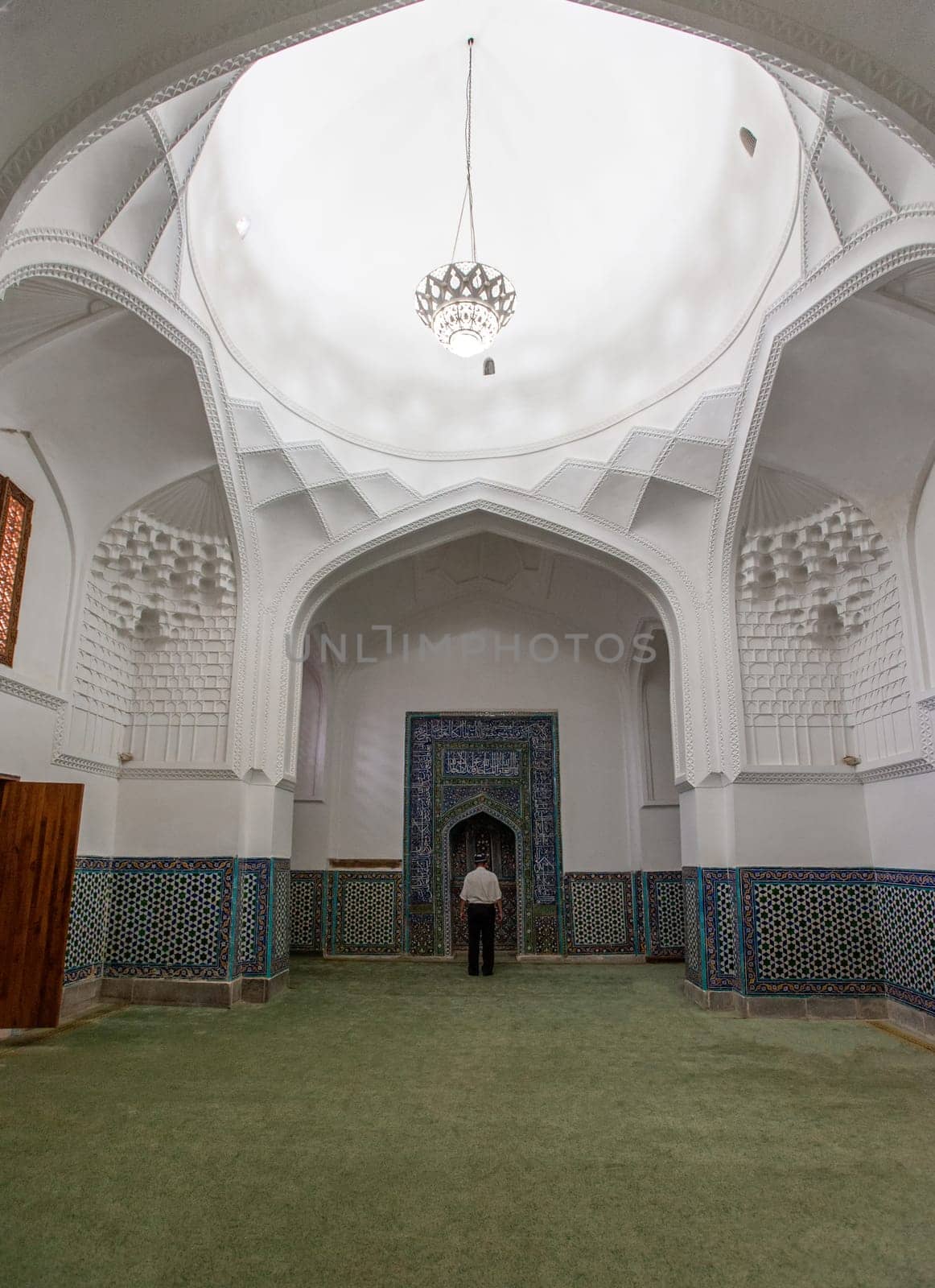 A man praying in the mosque in Samarkand, Uzbekistan