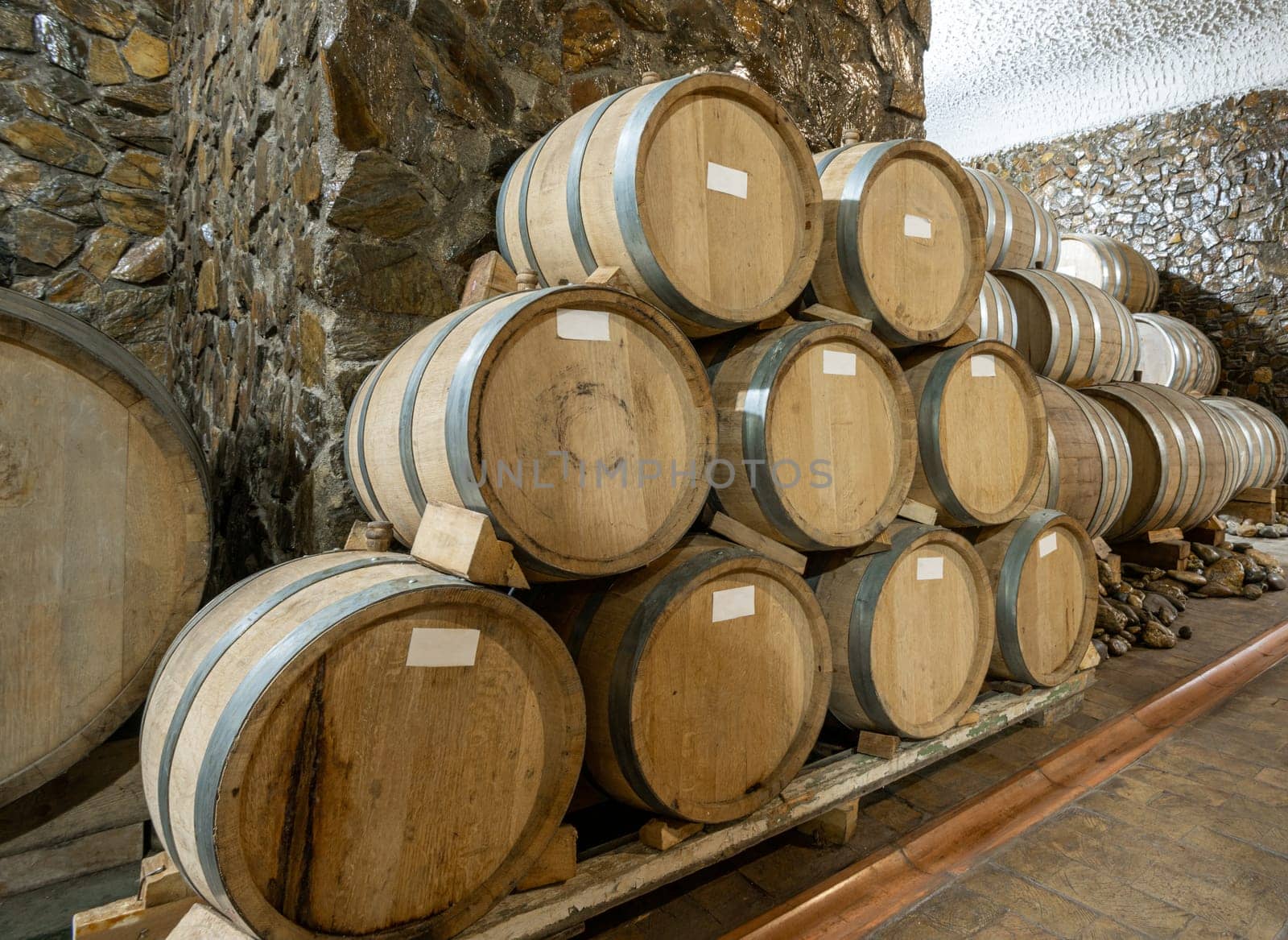 The wooden wine barrels in a wine factory by A_Karim