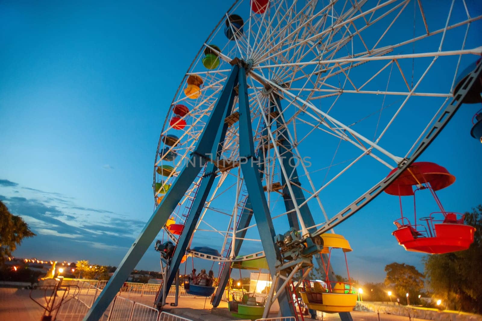 A attraction ferris wheel in the amusement park at night by A_Karim