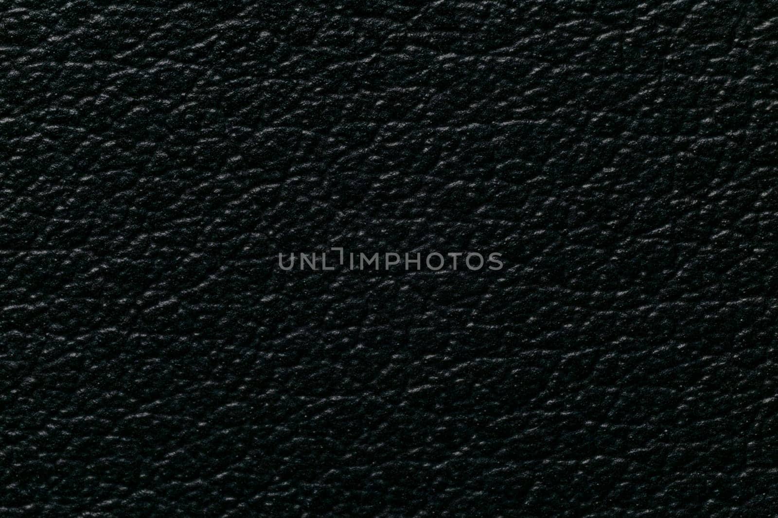 Black leatherette texture, eco-leather, close-up macro view by clusterx