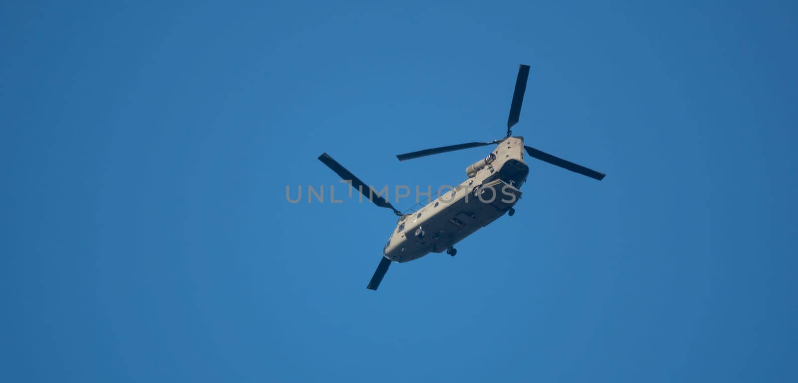 big chinook helicopter flying with blue sky as background