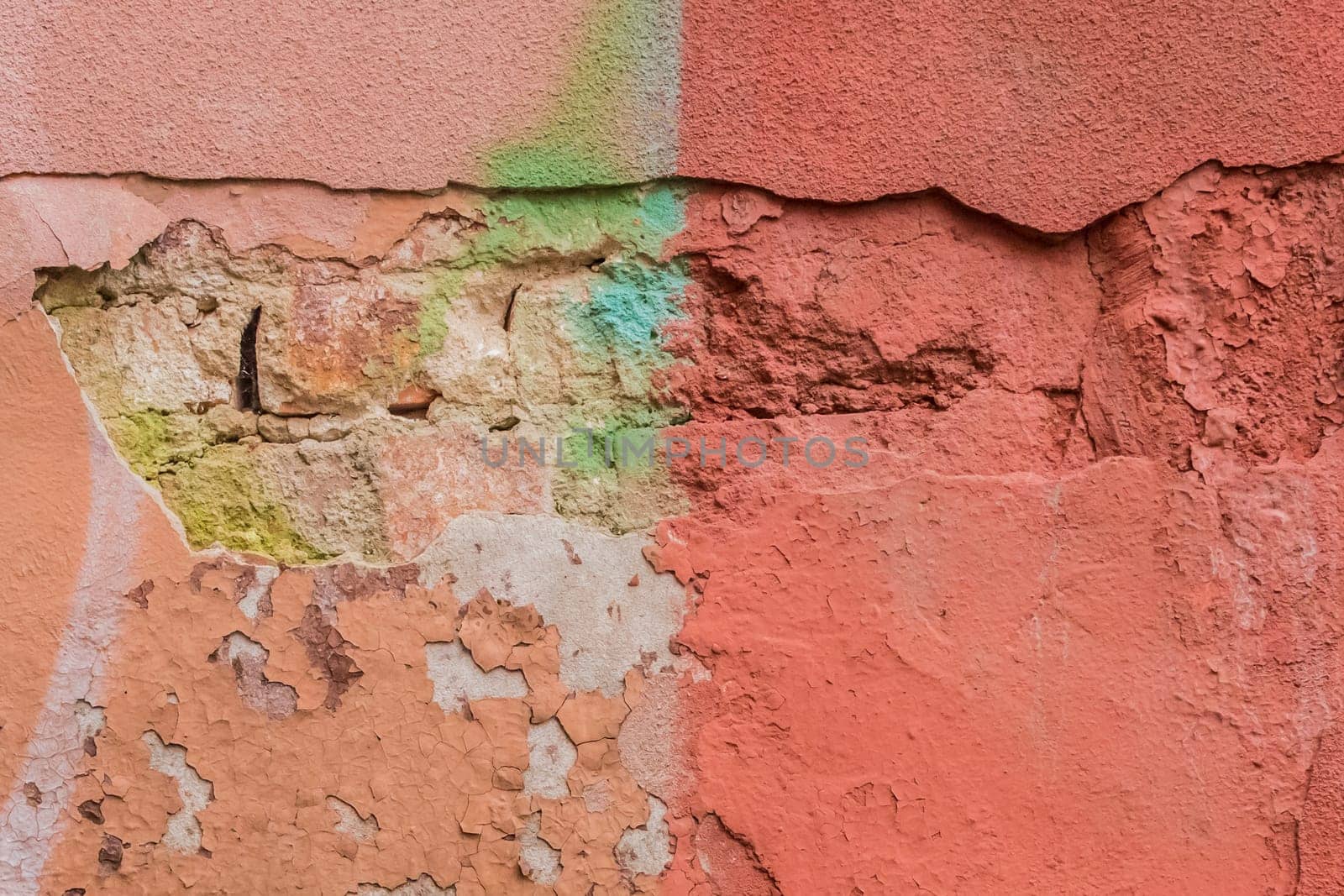 Old colored worn weathered concrete peeling plaster wall texture background.