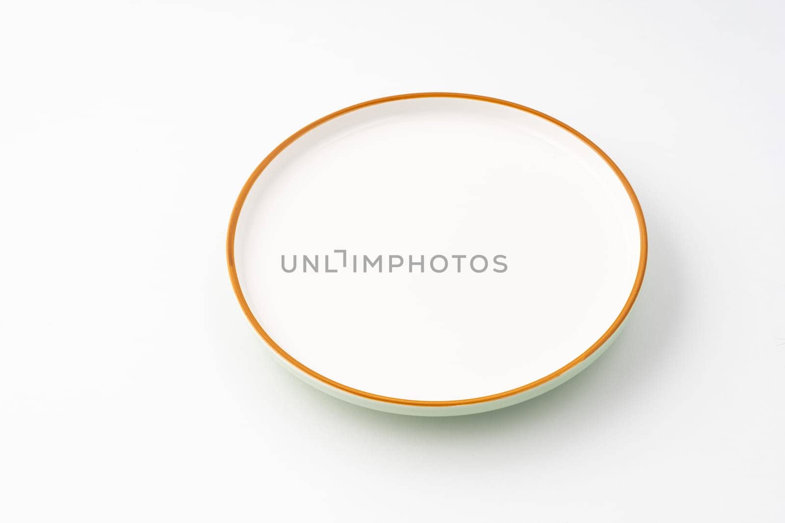 A one ceramic green plate isolated on white background