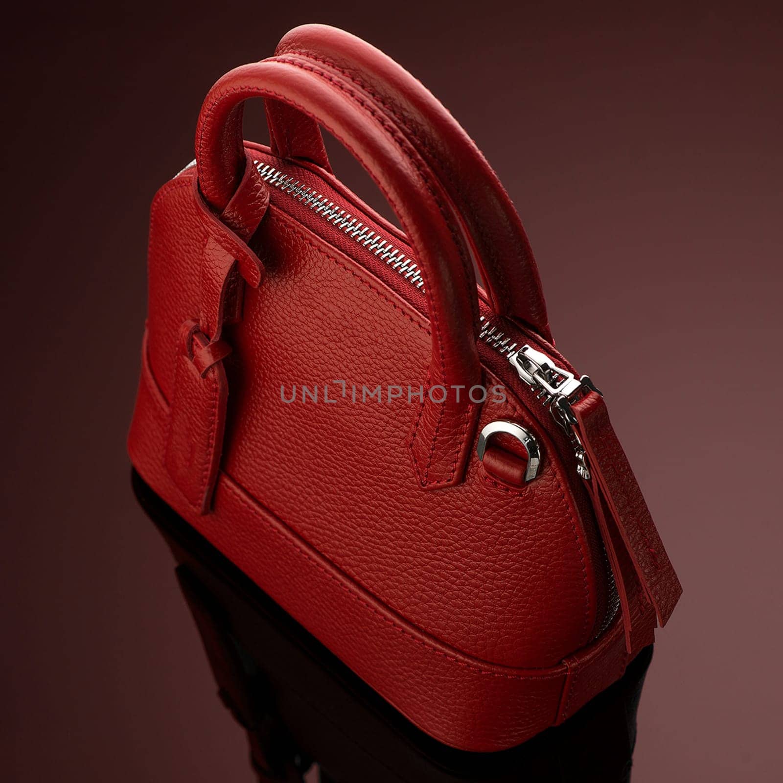 A closeup shot of a luxury red leather bag by A_Karim