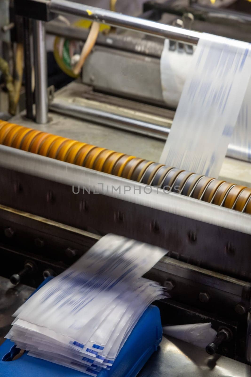 A vertical shot of a machine printing syringe labels at a medical production warehouse