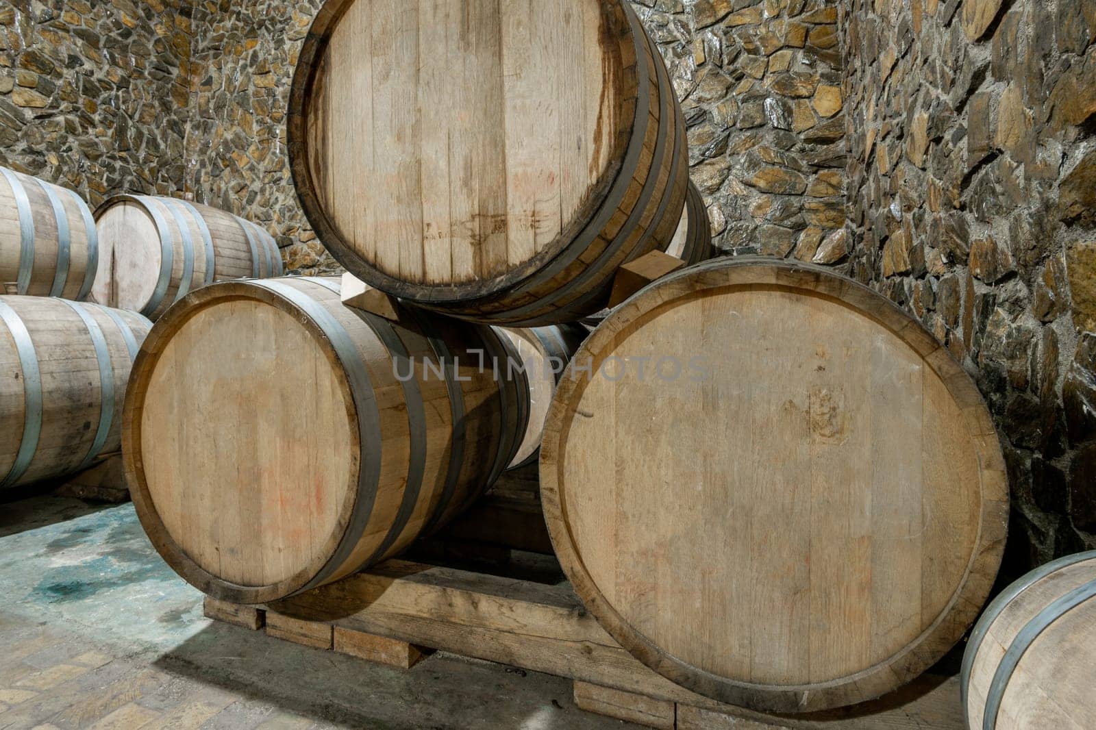The wooden wine barrels in a wine factory