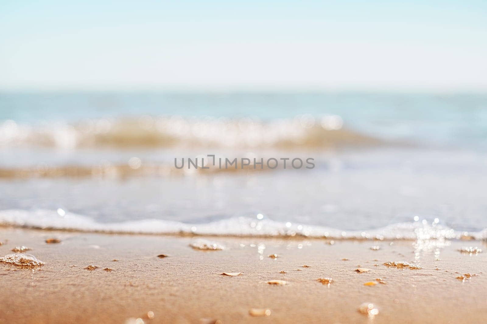 Closeup of sand on beach and blue summer sky. Panoramic beach landscape. Empty tropical beach and seascape