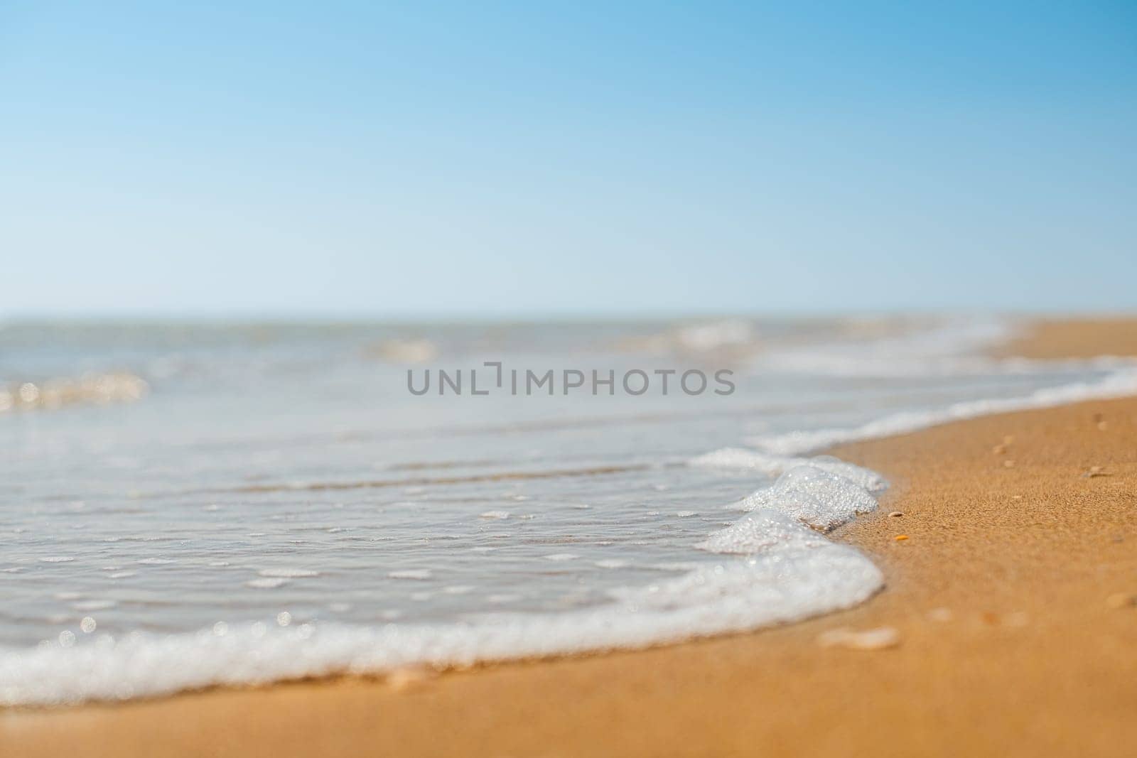Closeup of sand on beach and blue summer sky. Panoramic beach landscape. Empty tropical beach and seascape