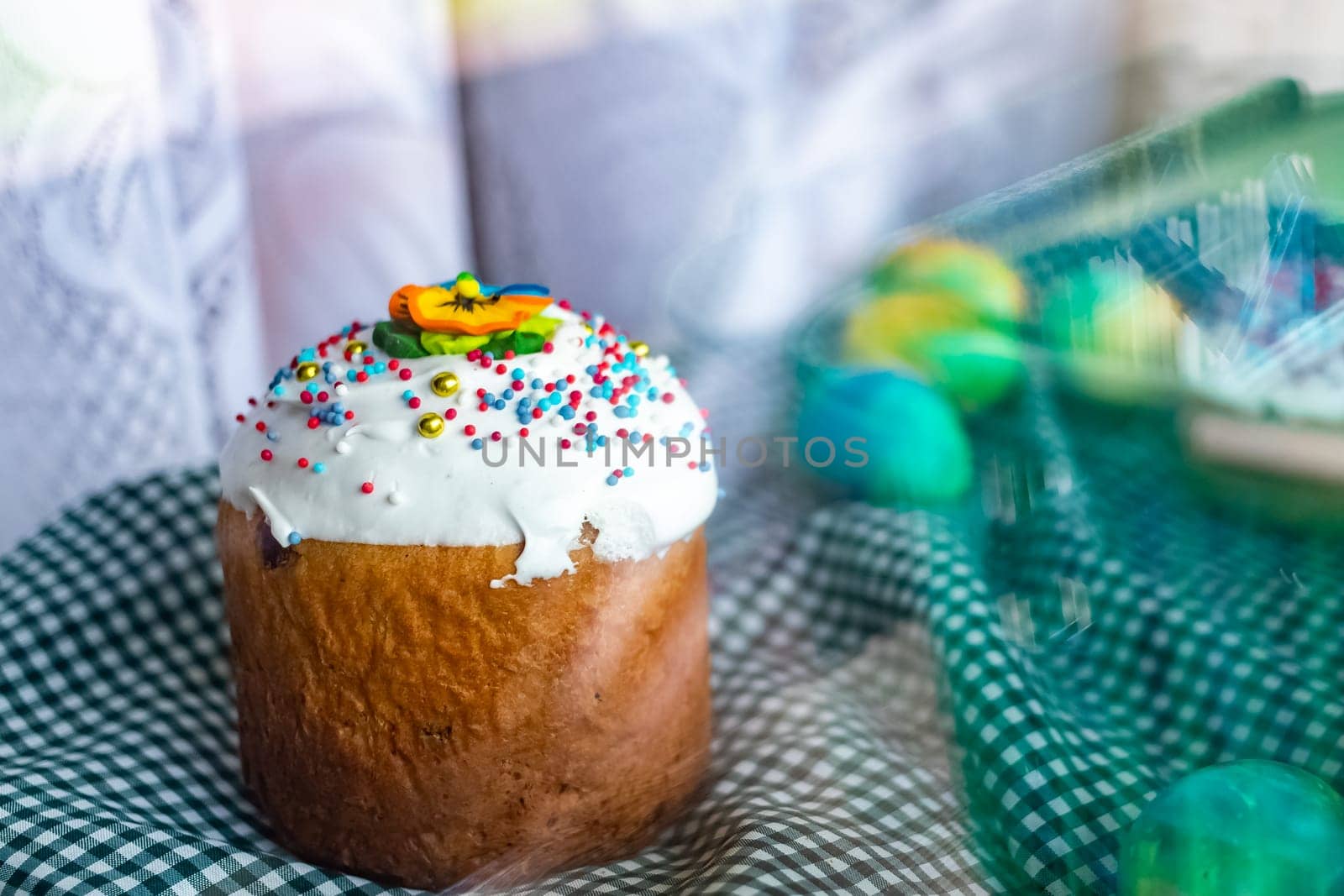 Traditional Russian Ukrainian Easter Cake Kulich. Orthodox Christian Easter Bread or Easter Cake with frosting, Easter Eggs and willow twigs on blue background. Copy space for text, place for design.