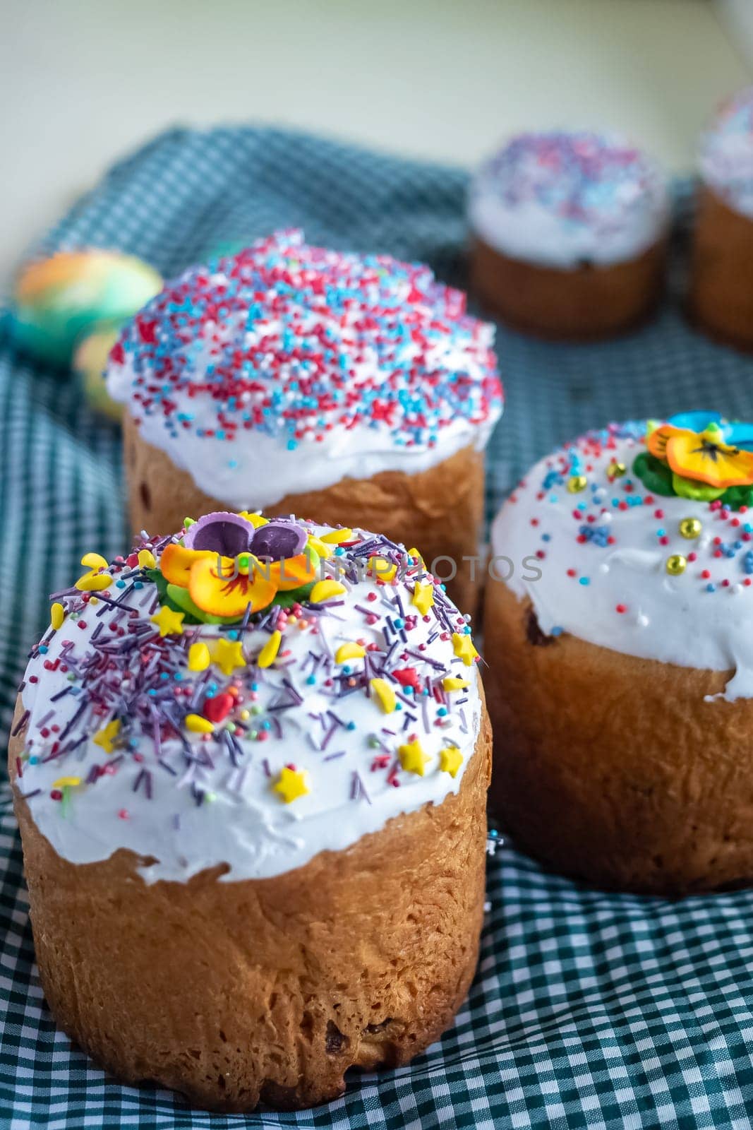 Traditional Russian Ukrainian Easter Cake Kulich. Orthodox Christian Easter Bread or Easter Cake with frosting, Easter Eggs and willow twigs on blue background. Copy space for text, place for design.