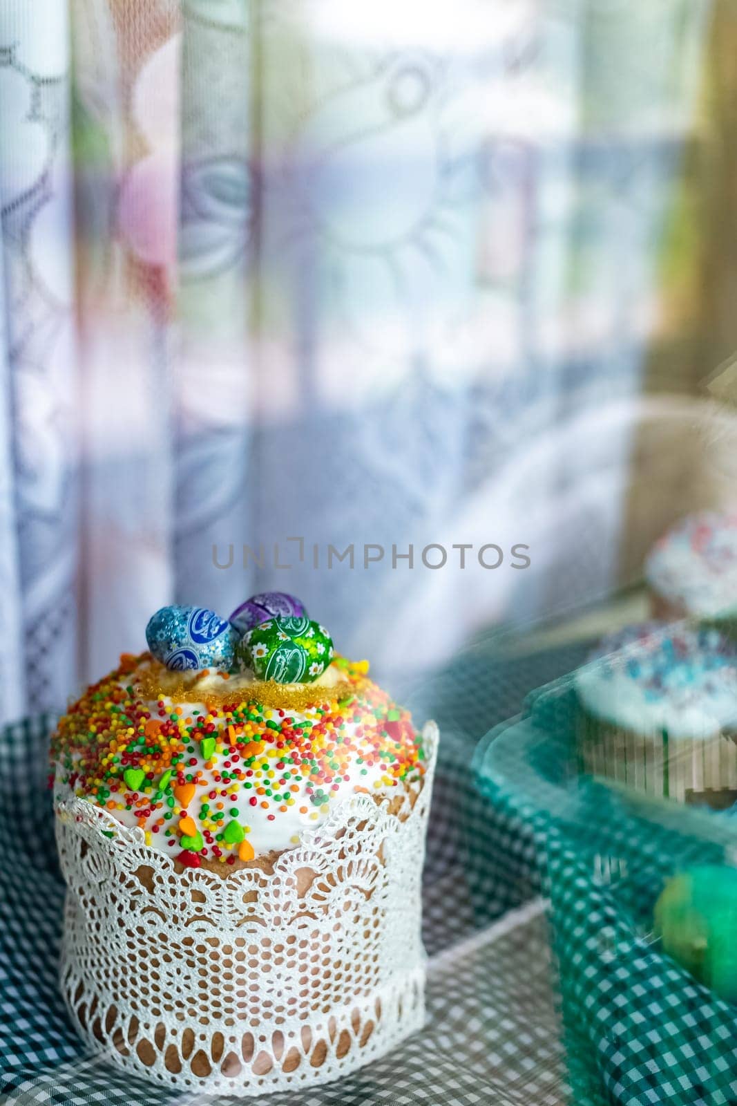 Easter cake and Easter eggs festive celebration table setting traditional decoration and treats. Happy easter holiday on the table meal snack outdoor top view copy space food background rustic.