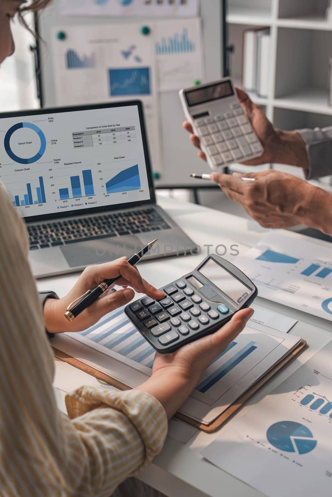 Two business people talk project strategy at office meeting room. Businessman discuss project planning with colleague at modern workplace while having conversation and advice on financial data report