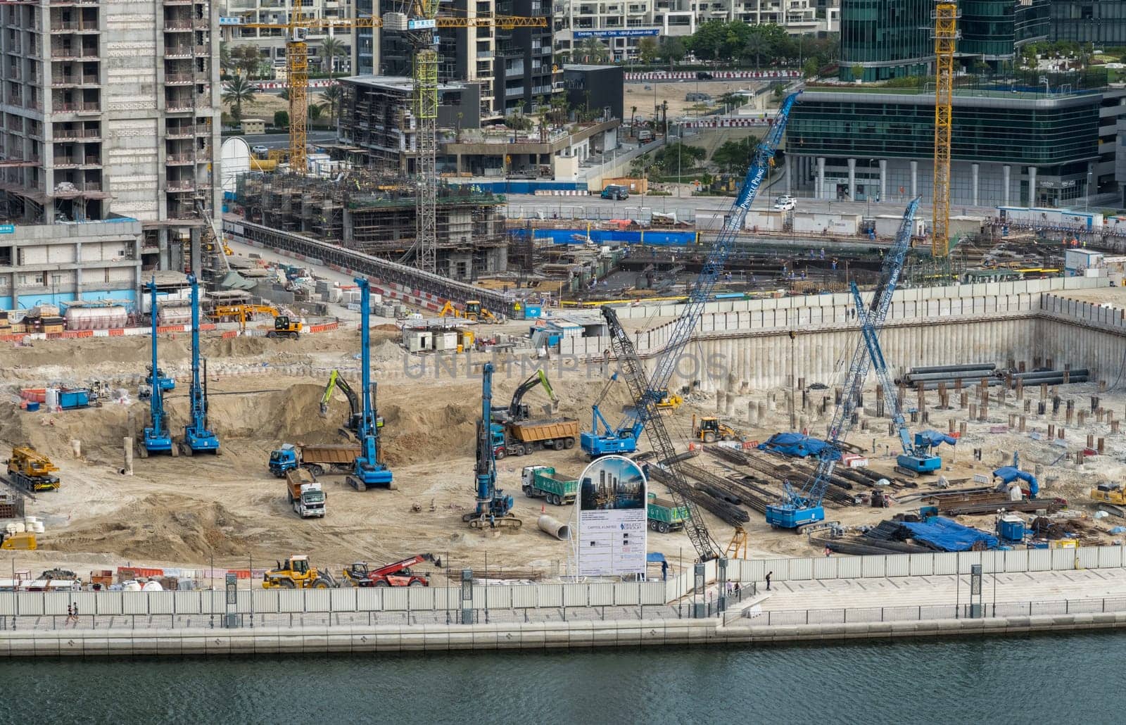 Dubai, UAE - April 1, 2023: Construction of new tower for apartments along canal in Business Bay