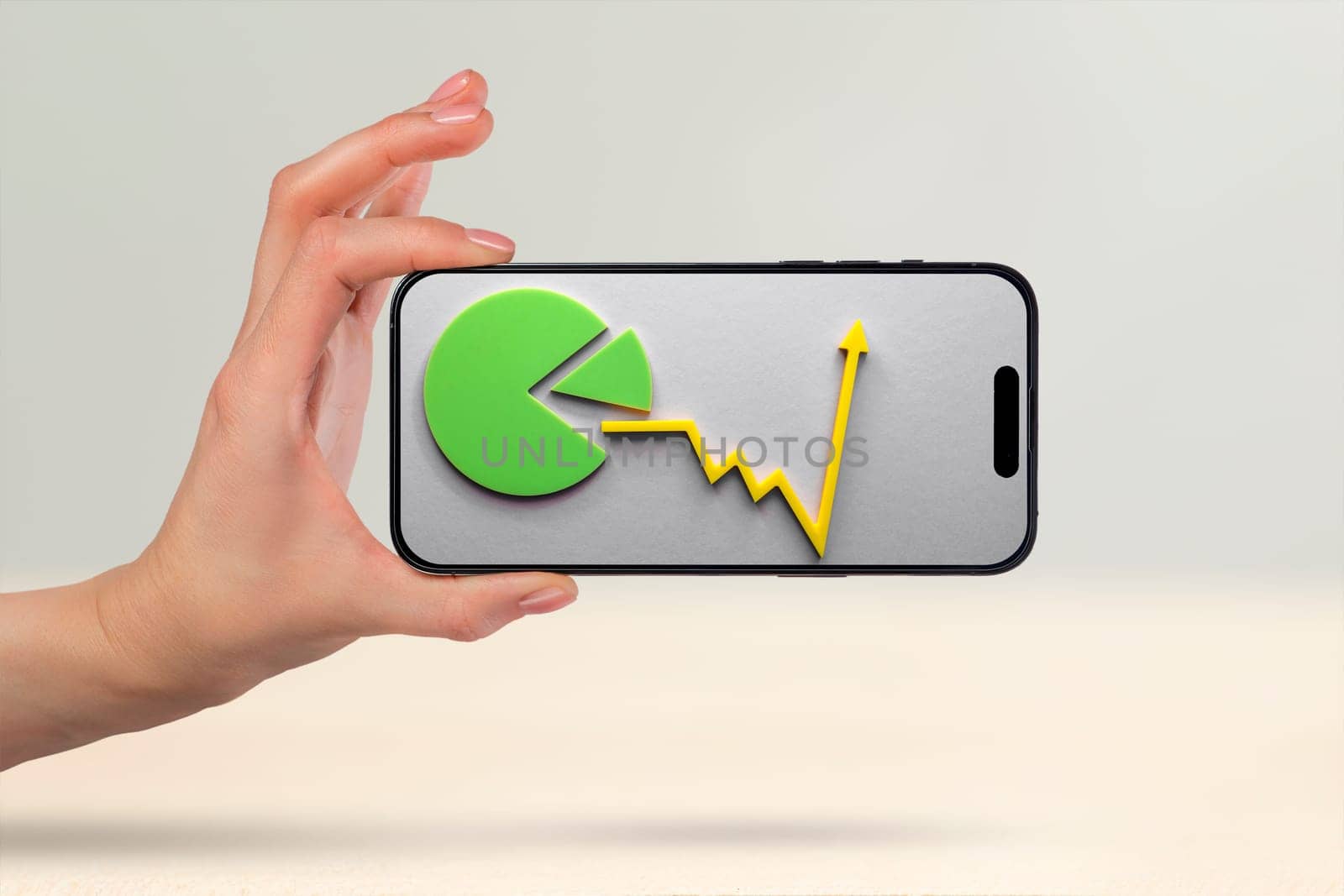 Financial market, purchase of shares, annual or quarterly reports of companies. Forecast of growth in the financial market. Phone in hand, financial graph and growth chart on phone screen.