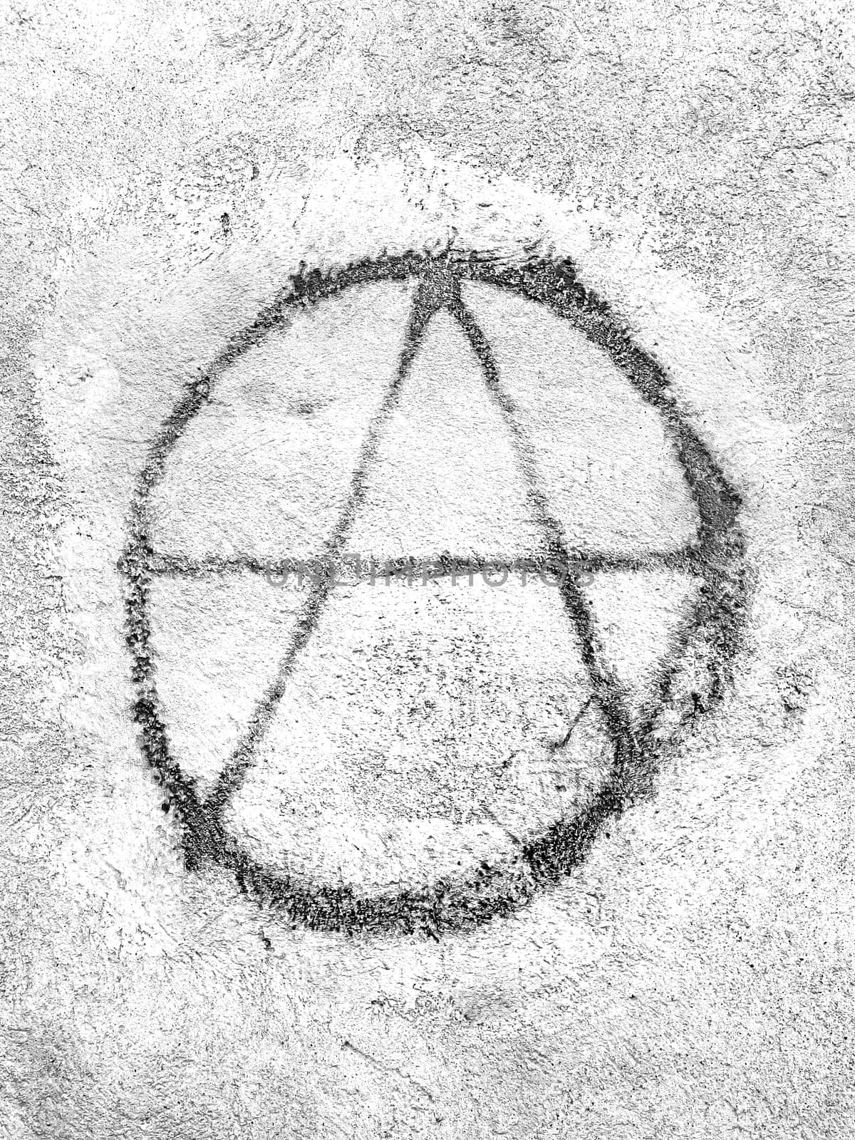 Symbol of anarchy painted on the wall. Graffiti.