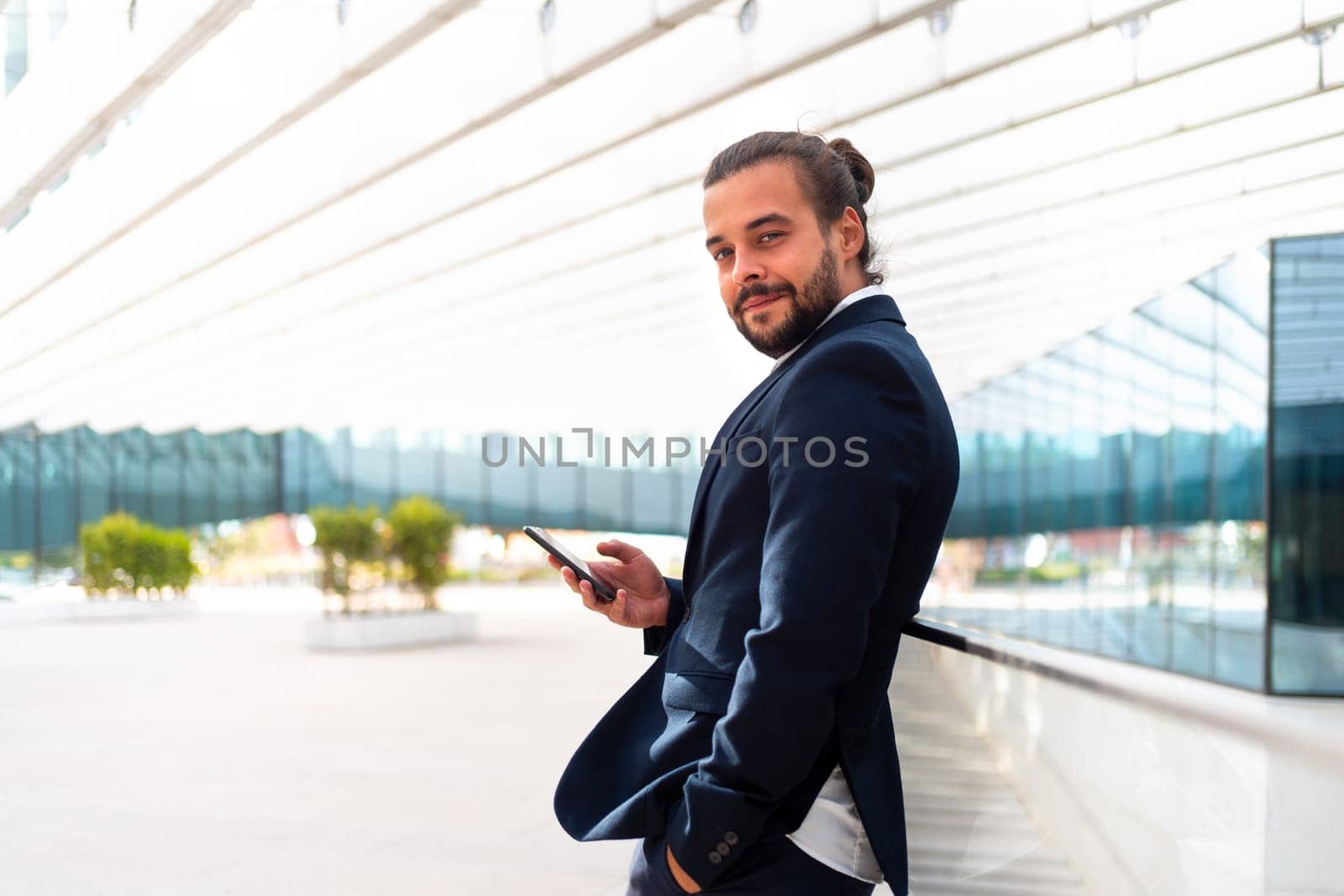 Businessman standing outdoor use smartphone by andreonegin