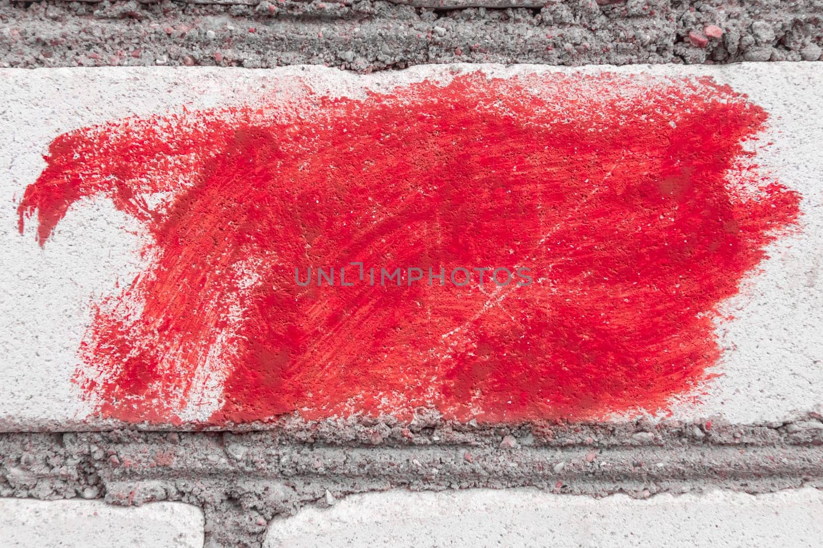 Red paint spot brush stain abstract pattern art urban wall background design.