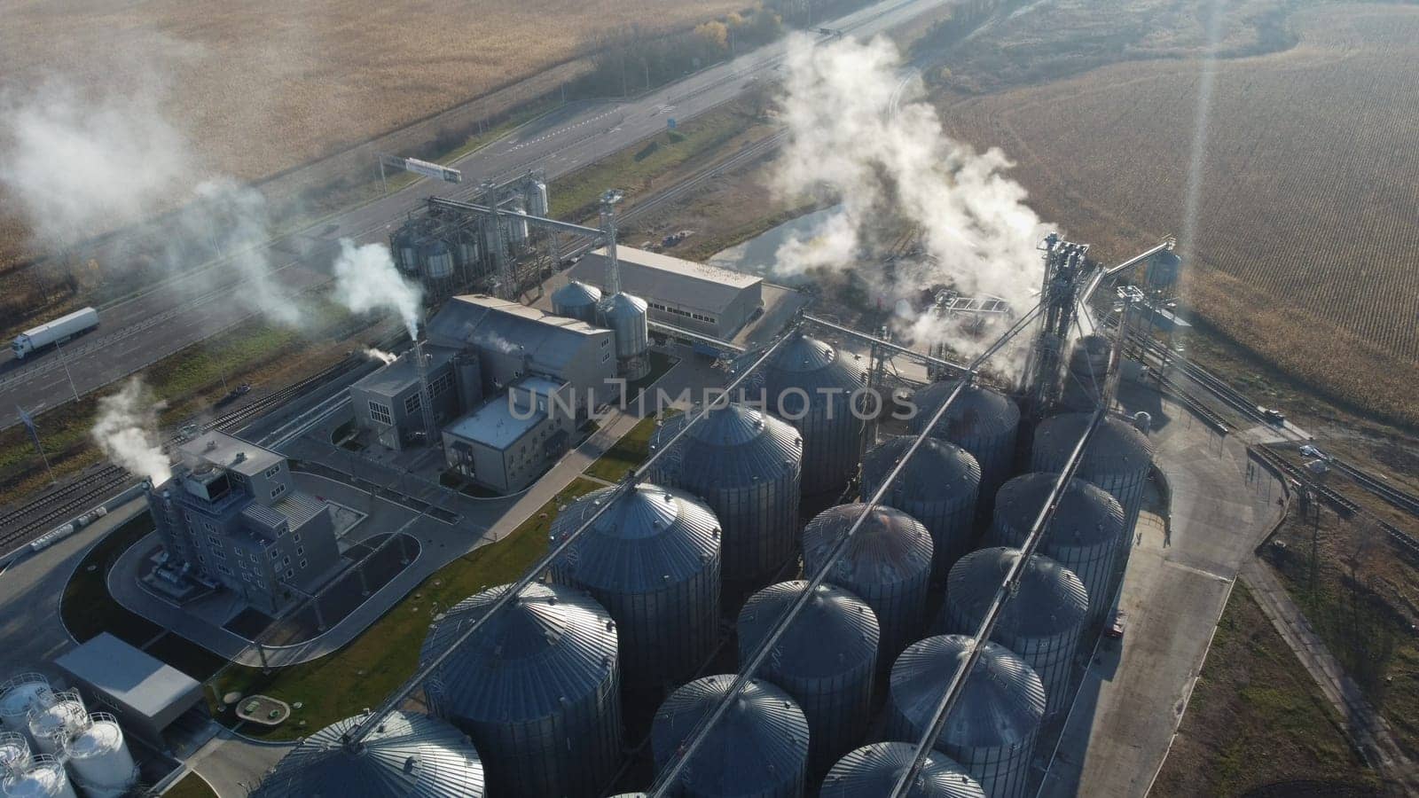 Grain elevator. Granary. Large metal structure grain elevator. Storage facility for grain. Top view. Grain storage. Silos. Metal hangar for cereal. Modern new elevator plant. agricultural agribusiness