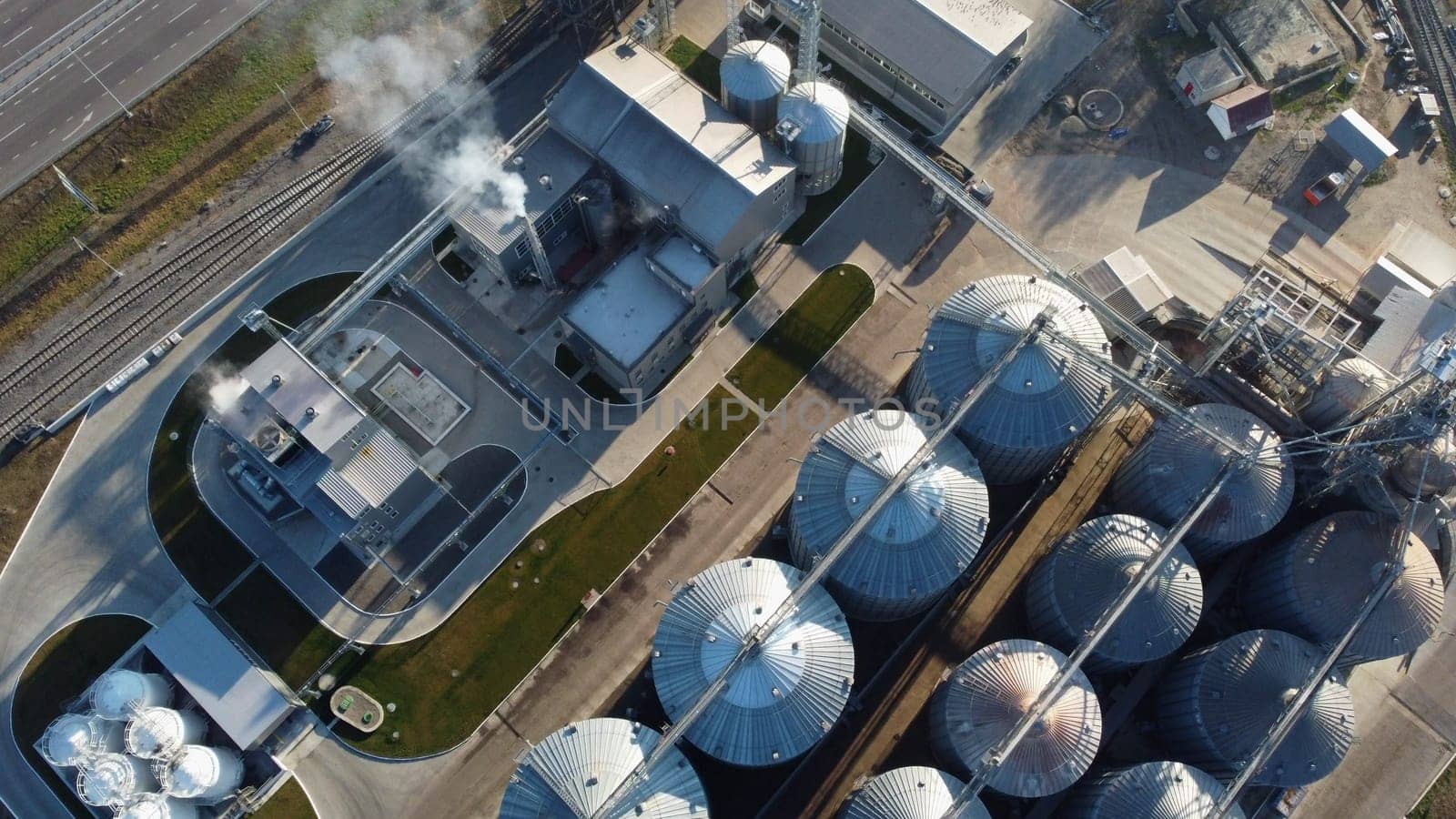 Grain elevator. Granary. Large metal structure grain elevator. Storage facility for grain. Top view. Grain storage. Silos. Metal hangar for cereal. Modern new elevator plant. agricultural agribusiness