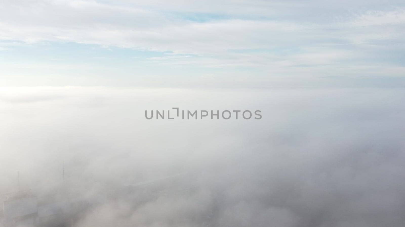 Sky clouds fog. Aerial drone view of blue sky and white clouds. View of fog from above and sky with clouds. Fog movement over city. View from above. Abstract natural background. Nature backdrop.