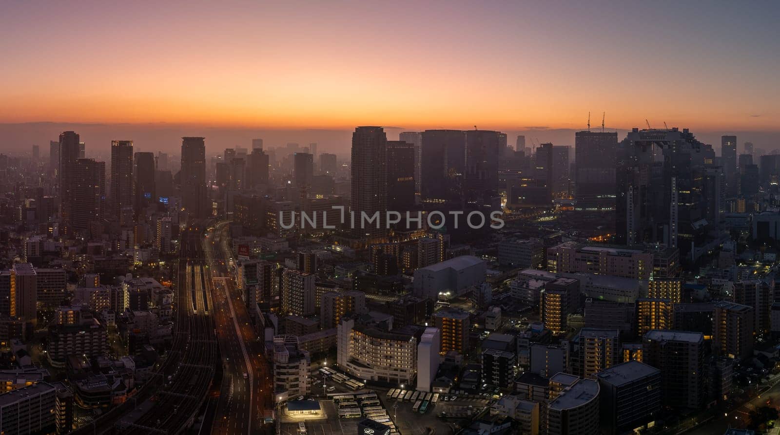 Panoramic view of downtown Osaka from the air on a hazy morning.