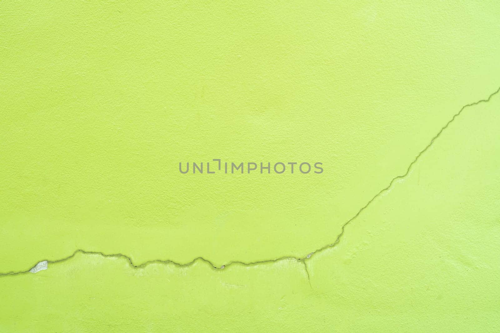 Green color with an old grunge wall concrete texture as a background.