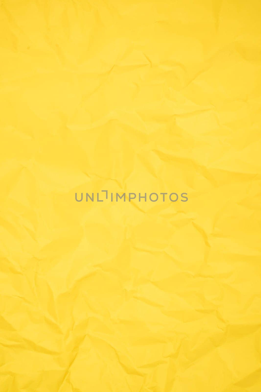 Abstract vertical yellow color creased paper texture as background.
