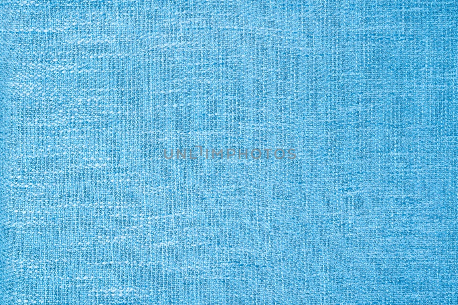 Close up shot of colored light blue fabric texture as background.