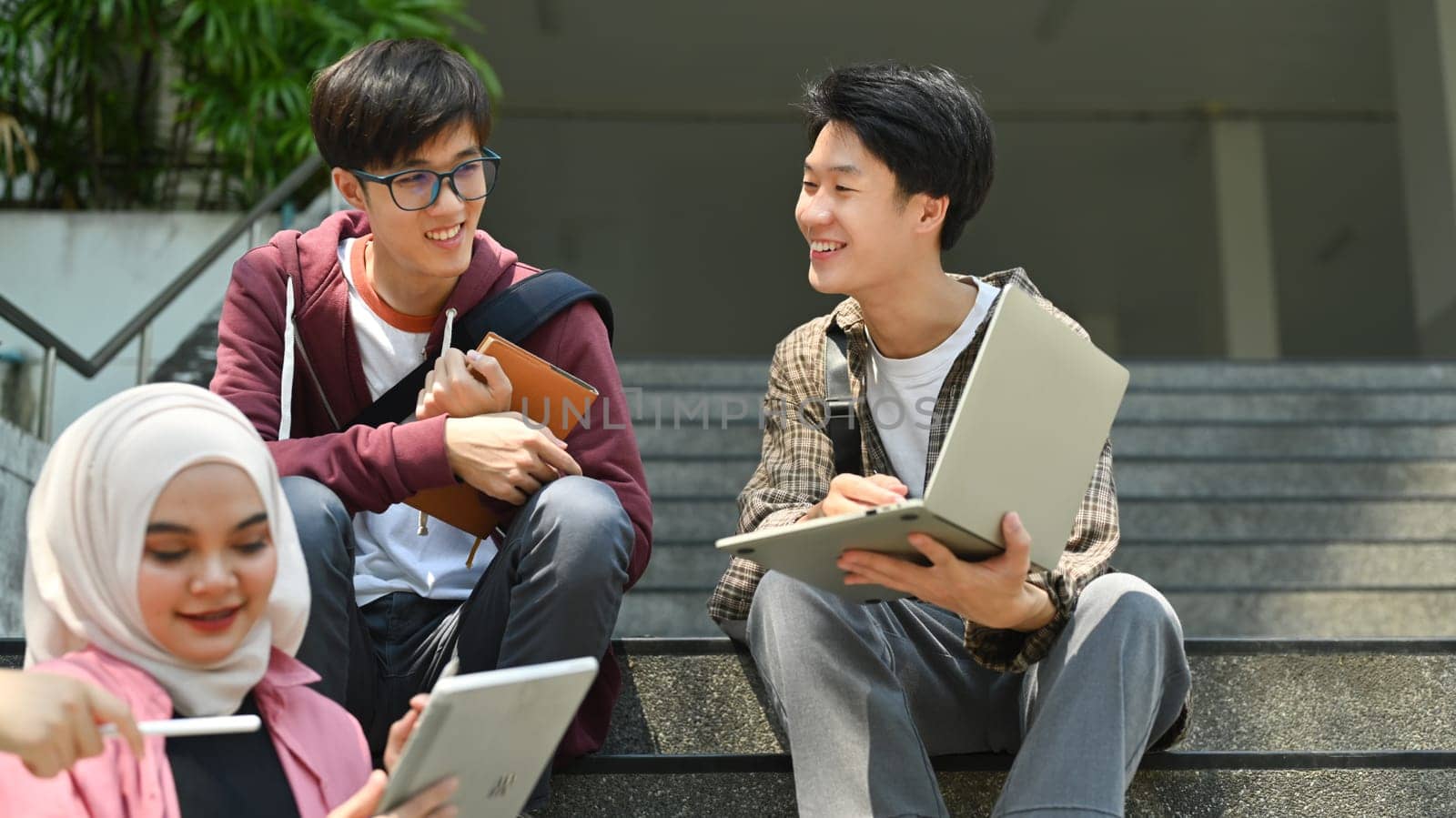 Group of students are working on academic project or preparing for exam together. Education, Learning and technology concept.