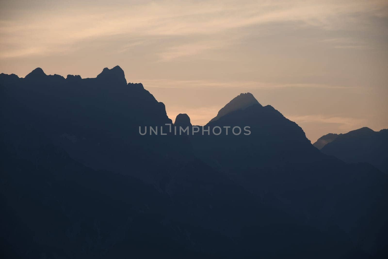 Mountains silhouette with peaks in the morning mist Saalfelden, Salzburg, Austria