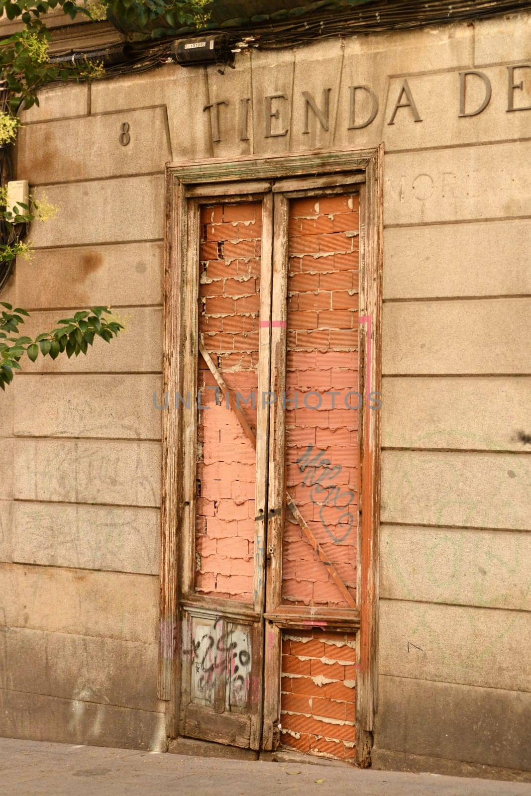 Vertical shot of a bricked-up door of an old house in Madrid, Spain