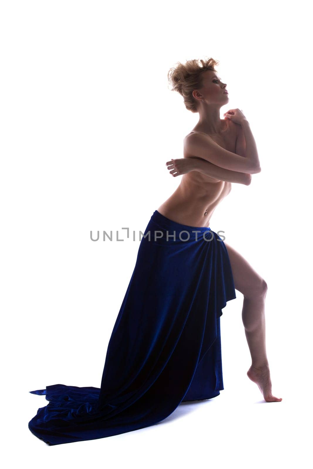 Image of graceful topless blonde posing in studio, isolated over white background