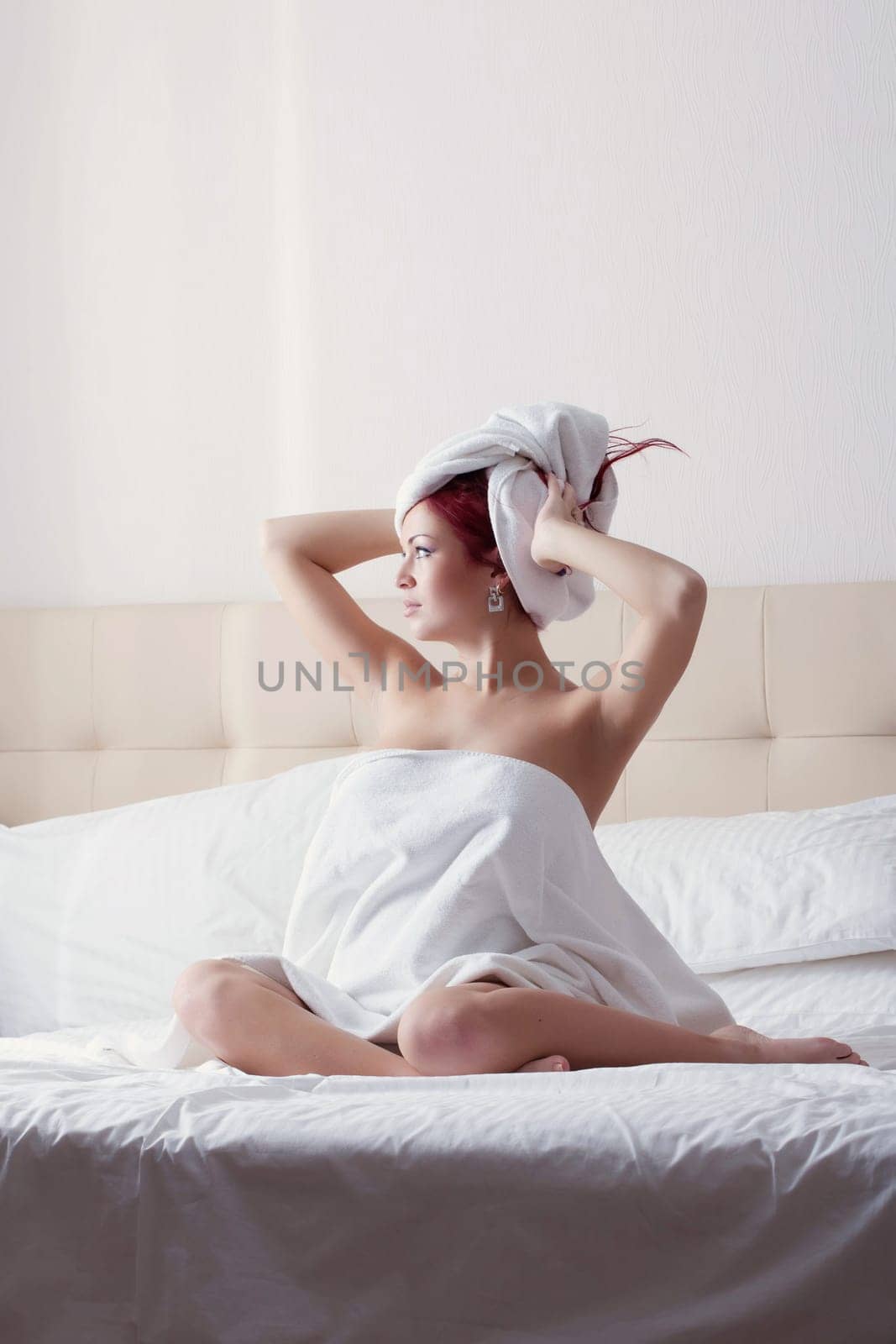 Portrait of beautiful red-haired girl posing after shower