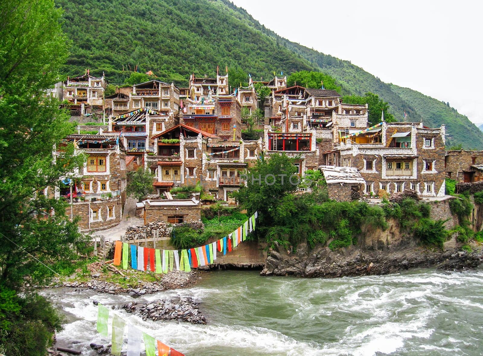 old Tibetan village crossed by a mountain river, travel reportage