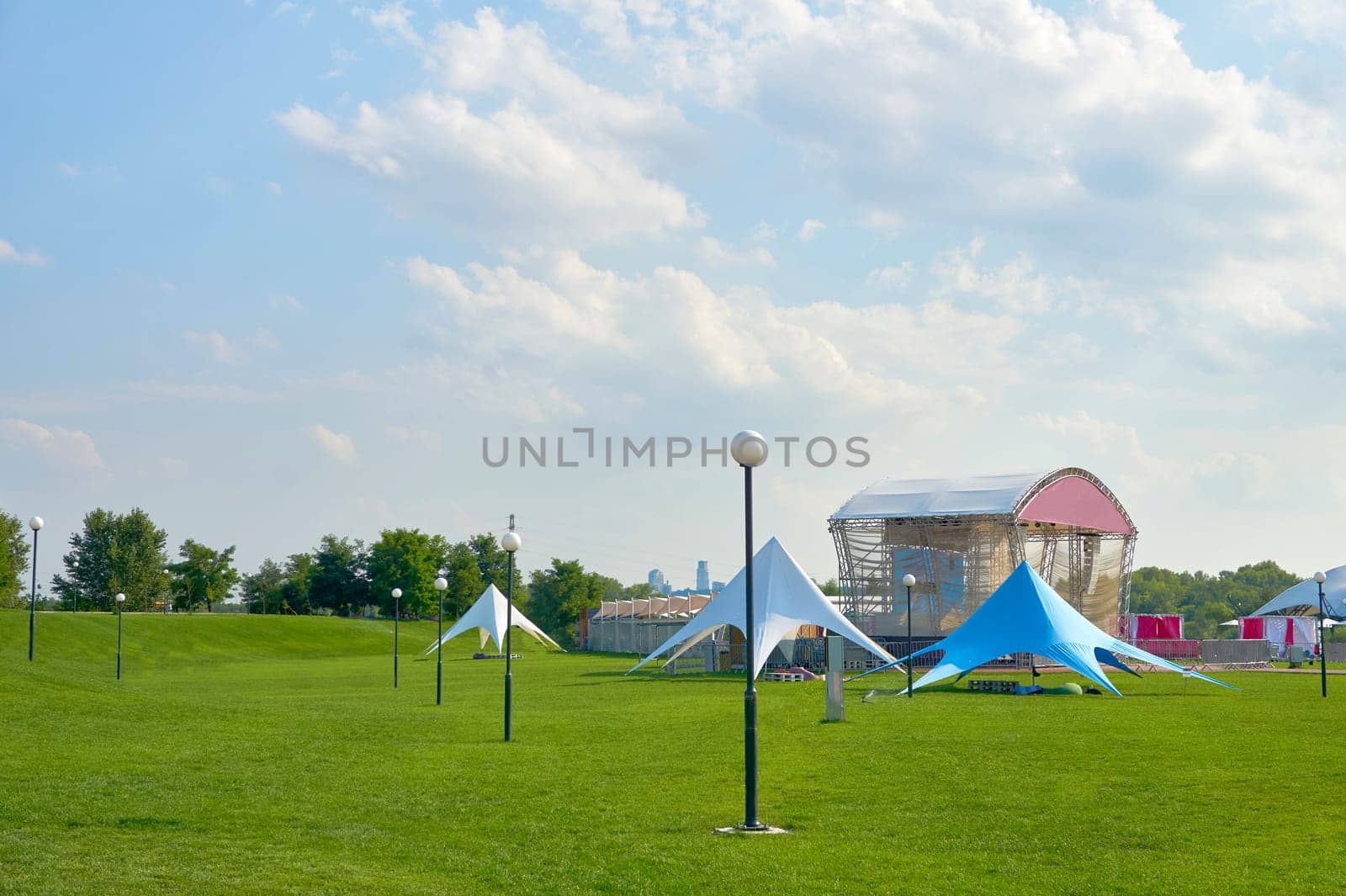 the state or experience of finding something funny. Green large lawn on a warm day in a summer spring amusement park
