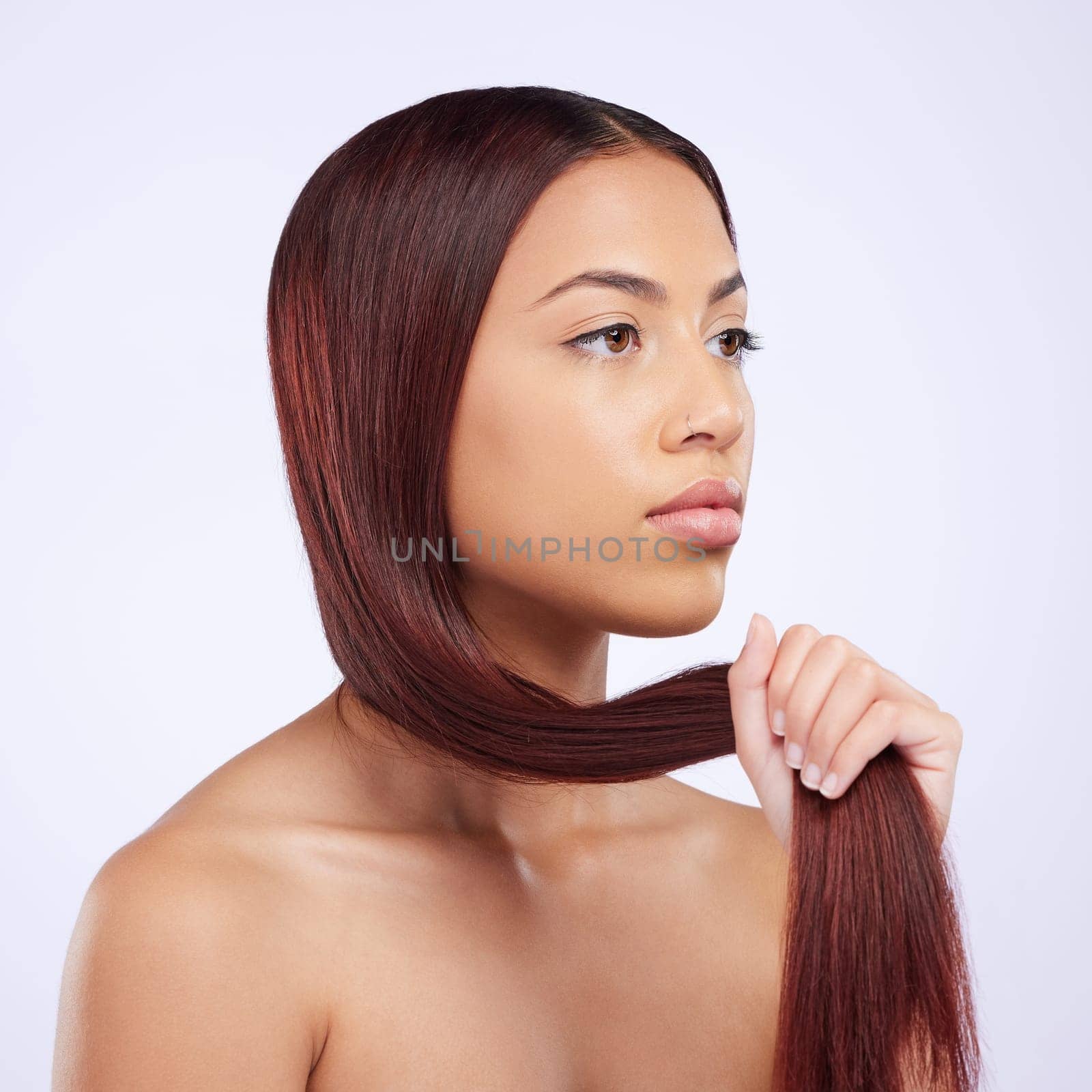 Haircare, beauty and woman holding hair, straight hairstyle and luxury salon shine isolated on white background. Haircut, keratin glow and serious expression of Brazilian model in studio backdrop