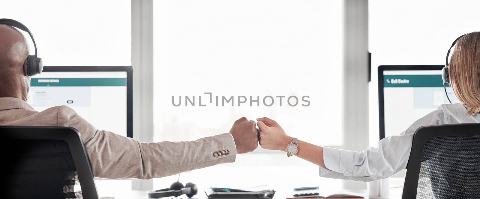 Business people, call center and fist bump for teamwork, collaboration or partnership in customer service at office. Back view of businessman or woman consultant agent touching hands in telemarketing.