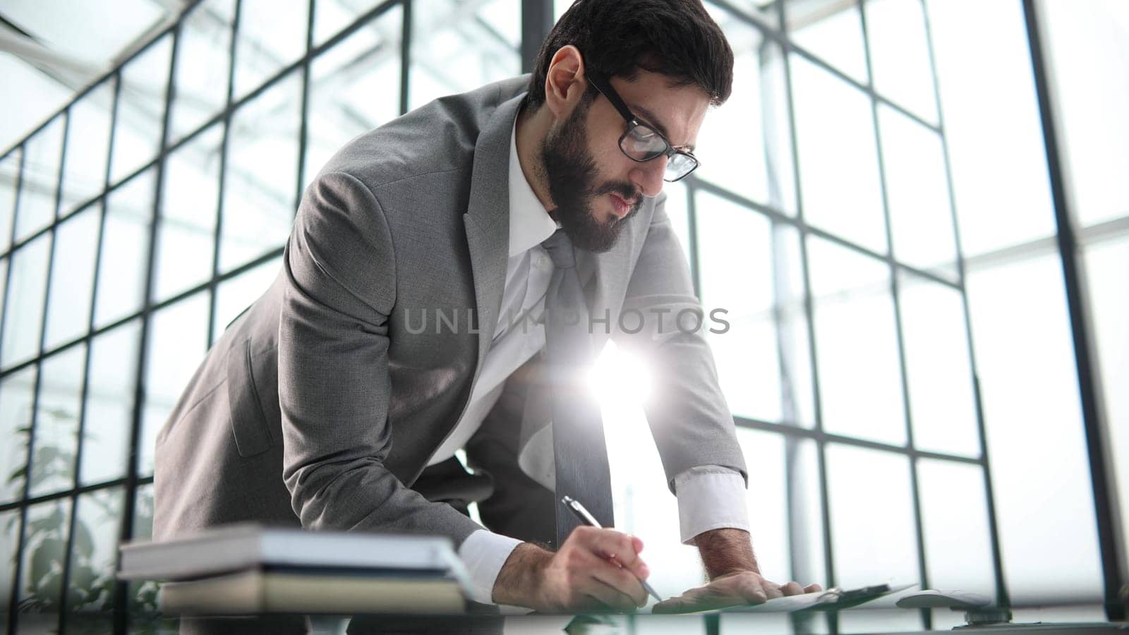 Young businessman signing a contract in the office