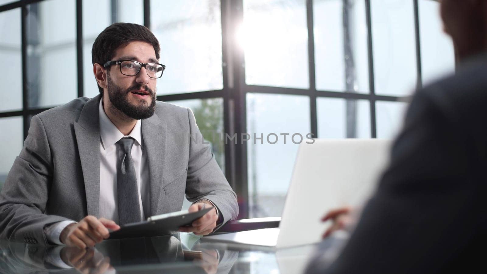 Two businessmen discussing project at meeting at office.