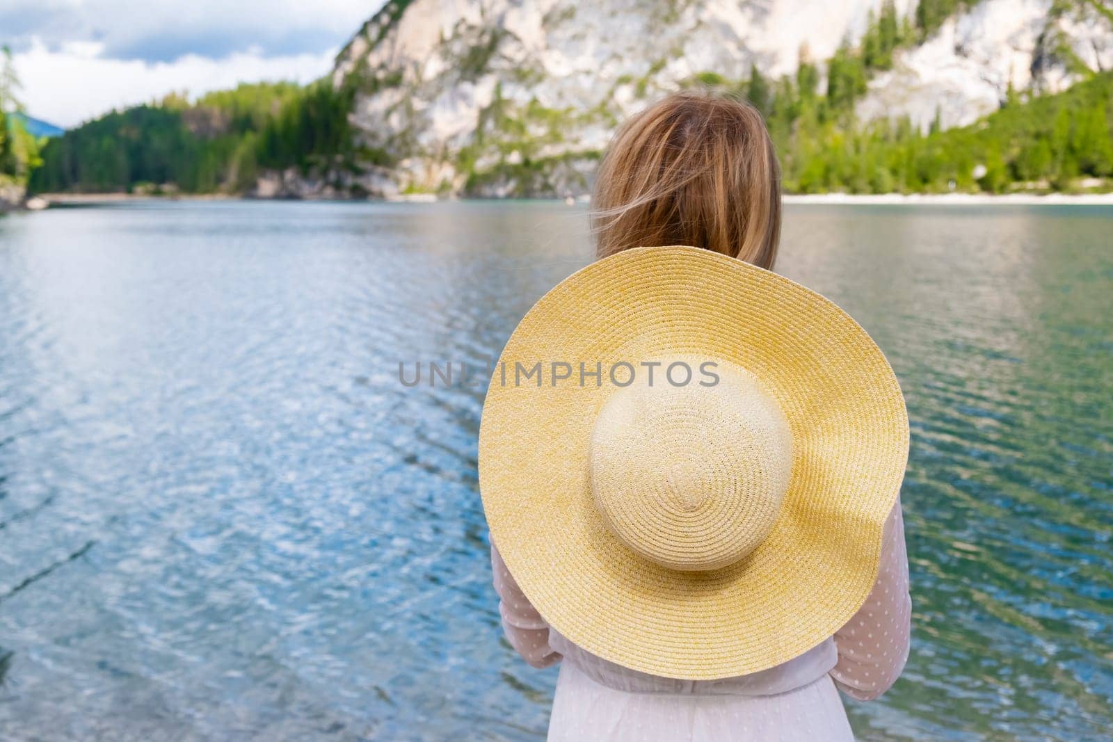 Beautiful woman has a vacation on the Lake Braies in Dolomites Alps. by vladimka