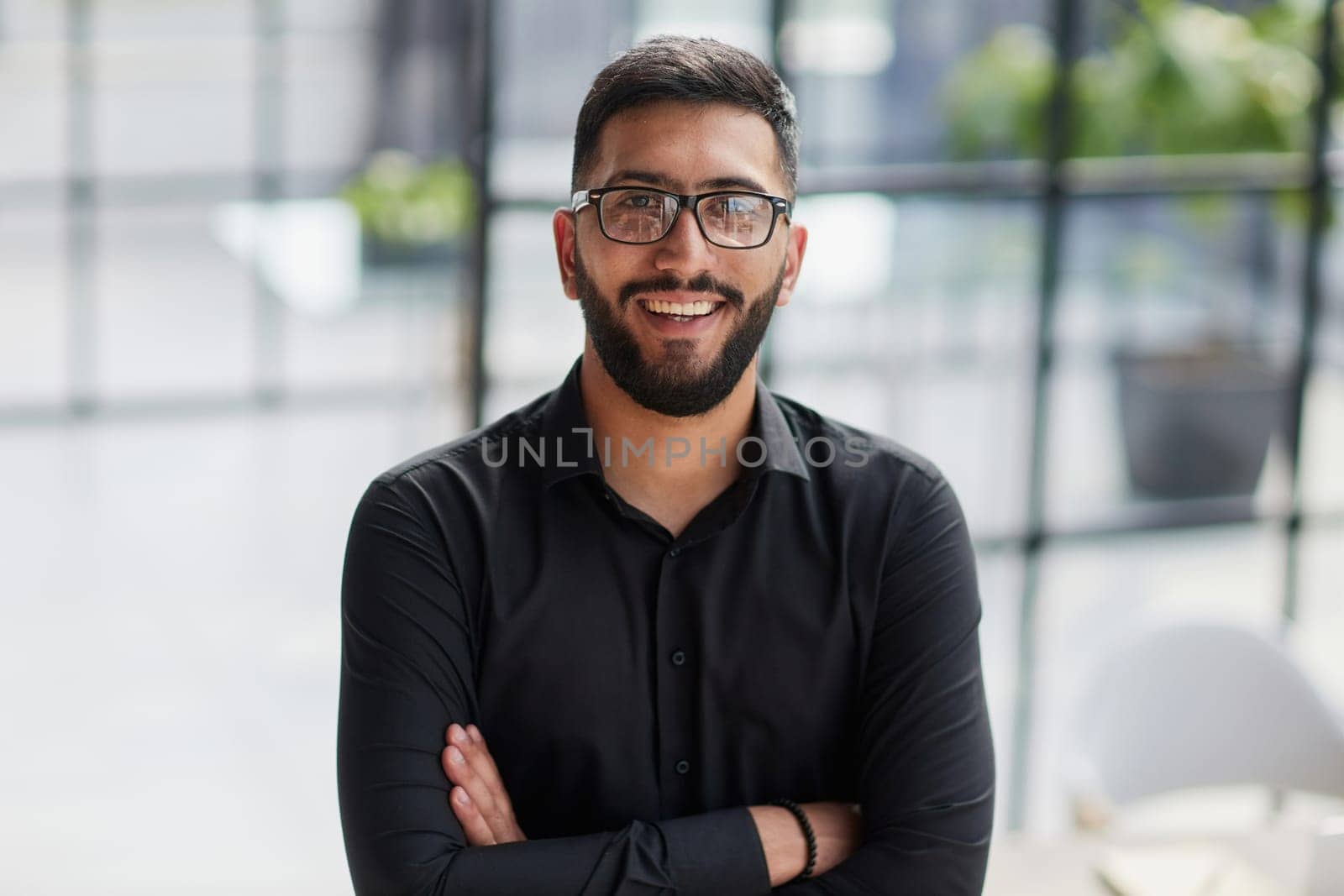 Businessman portrait. Happy confident young businessman standing , smiling, looking at camera.