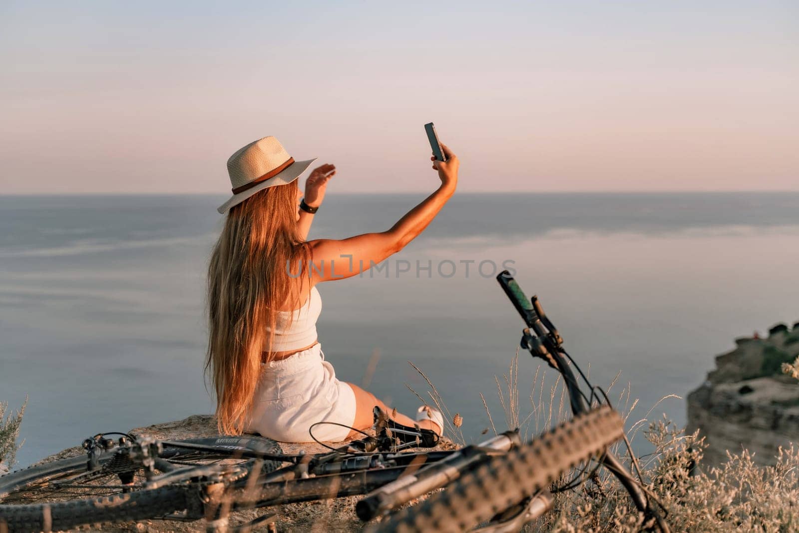 Selfie woman in cap and tank top making selfie shot mobile phone post photo social network outdoors on sea background beach people vacation lifestyle travel concept