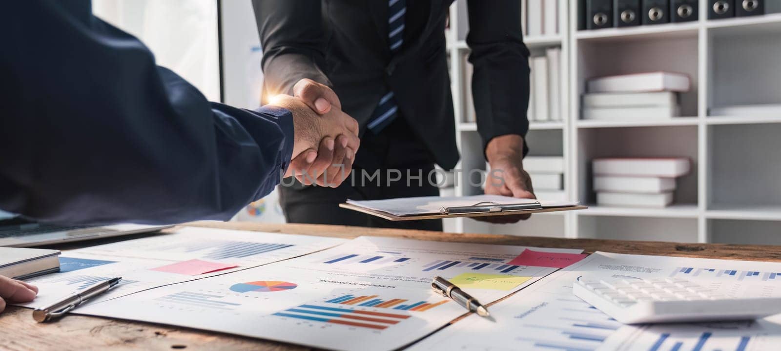 Business handshake for teamwork of business merger and acquisition,successful negotiate,hand shake,two businessman shake hand with partner to celebration partnership and business deal concept.