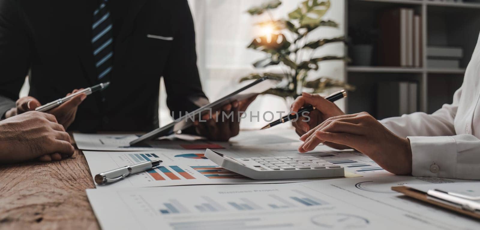 Business People Meeting using laptop computer,calculator,notebook,stock market chart paper for analysis Plans to improve quality next month. Conference Discussion Corporate Concept.. by wichayada