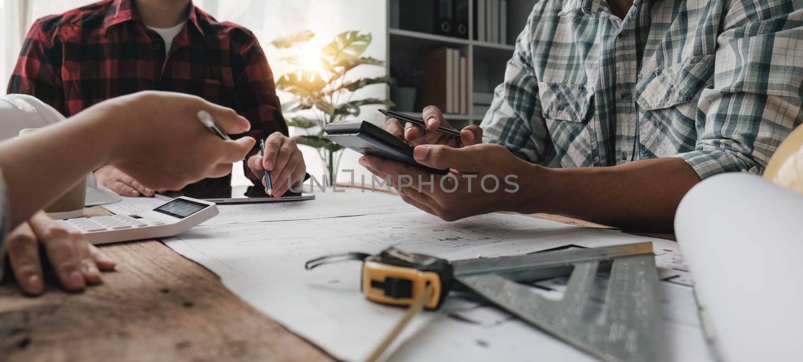 Civil engineer teams meeting working together wear worker helmets hardhat on construction site in modern city. Foreman industry project manager engineer teamwork. Asian industry professional team. by wichayada