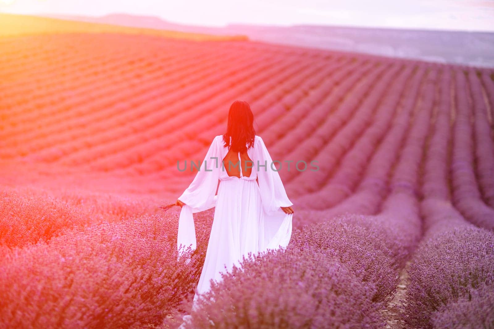 Lavender field happy woman in white dress in lavender field summer time at sunset.