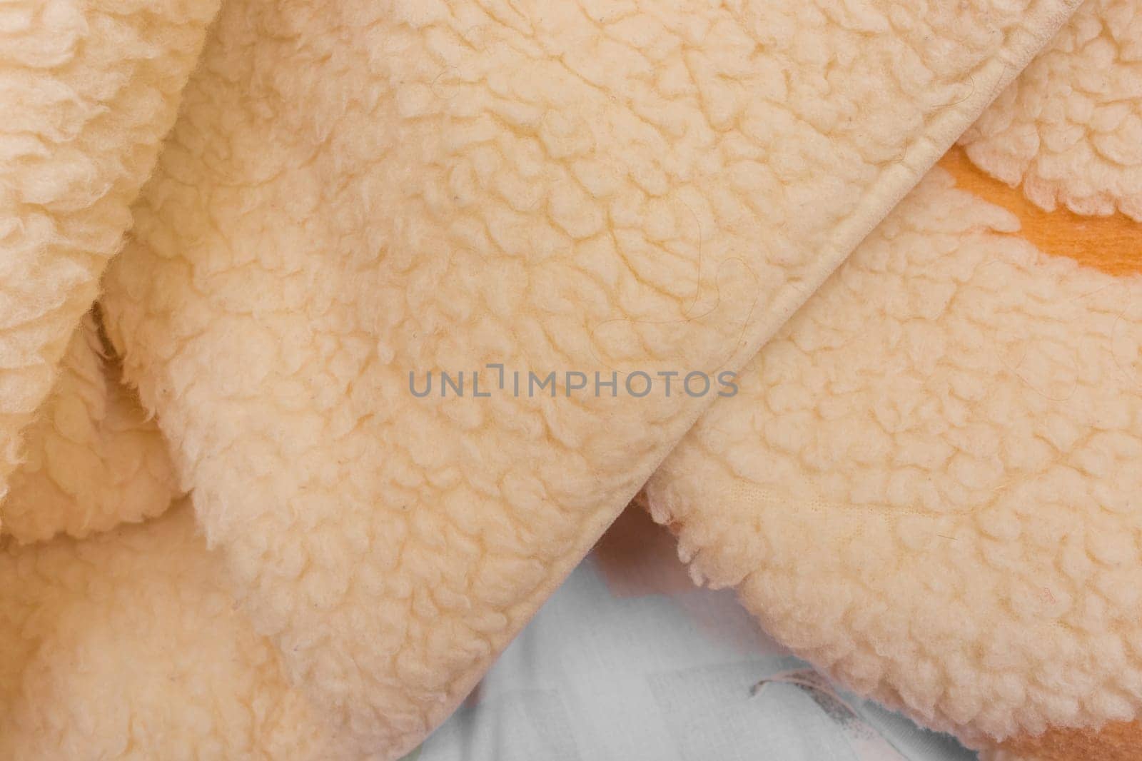 Yellow sheep material wool fur soft structure fleece fabric background texture warm natural nature skin.