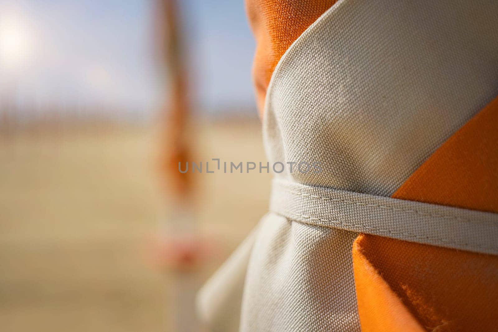 Close up umbrellas on the beach in Italy. The beach season is ready for opening. Travel concept
