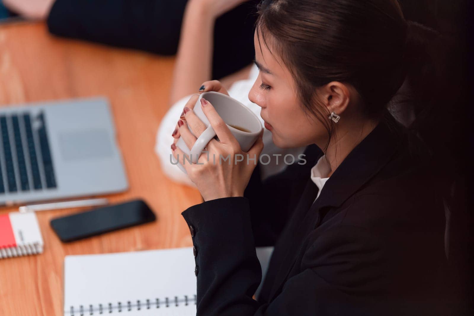 Businesswoman take coffee break, leisure in office after planning strategy, working in office for concept of harmony in workspace concept. Business office worker sitting professional meeting table.