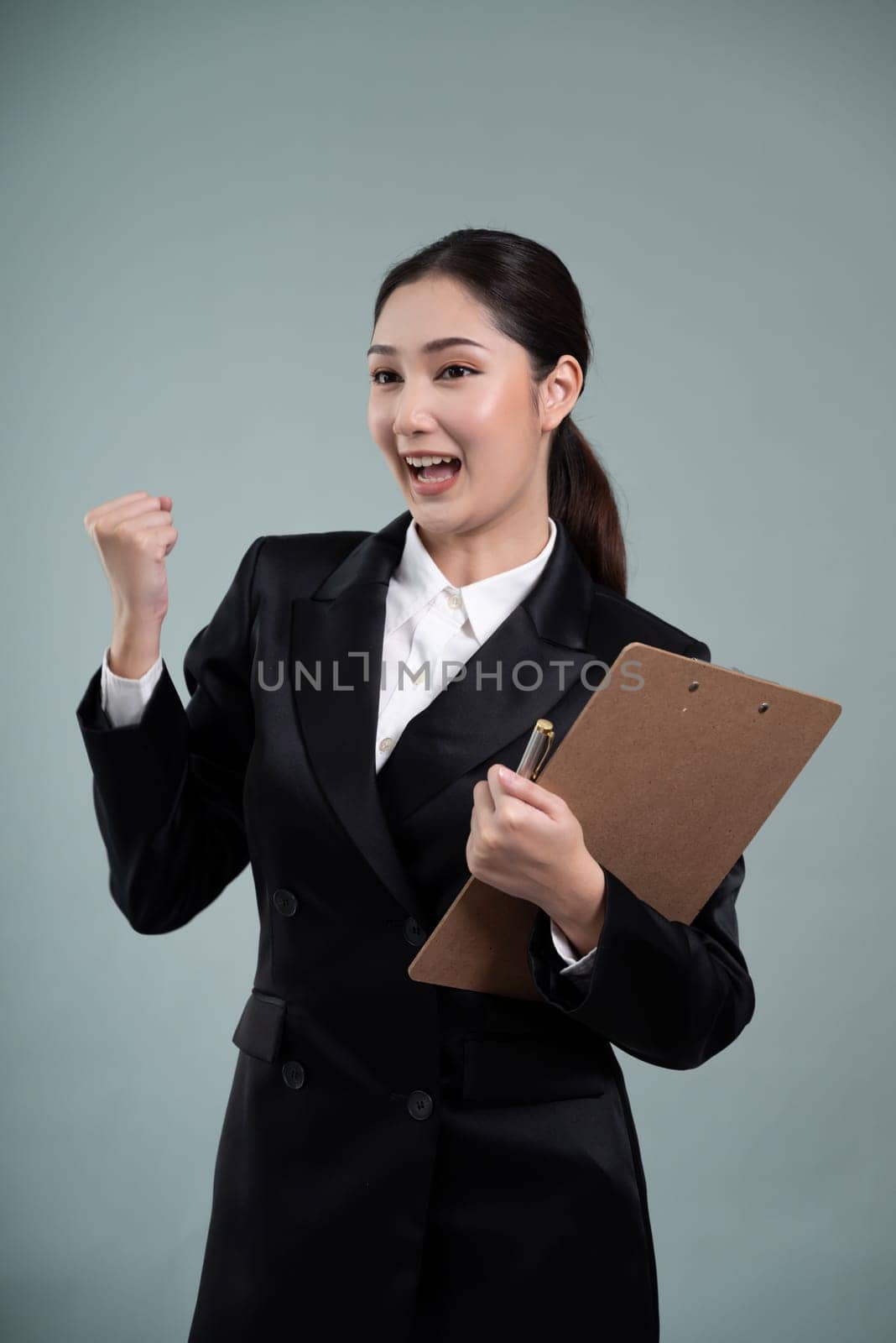 Confident young asian businesswoman making hand gesture. Enthusiastic by biancoblue